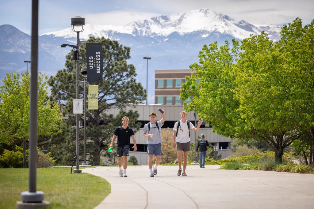 Three male students walking on campus